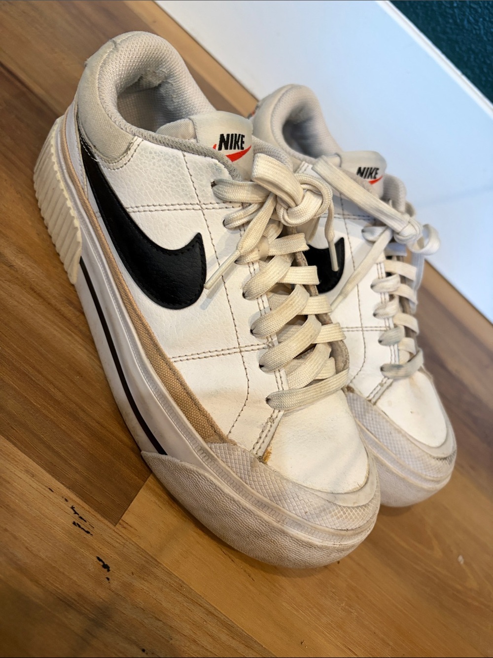 Nike Women's White Leather Sneakers with Black Swoosh and Tan Accent